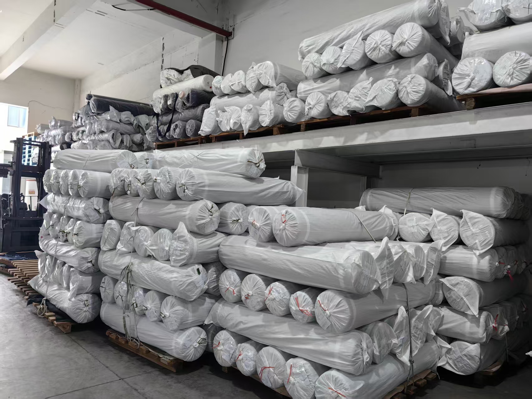 Fabric rolls stacked in the finished goods warehouse