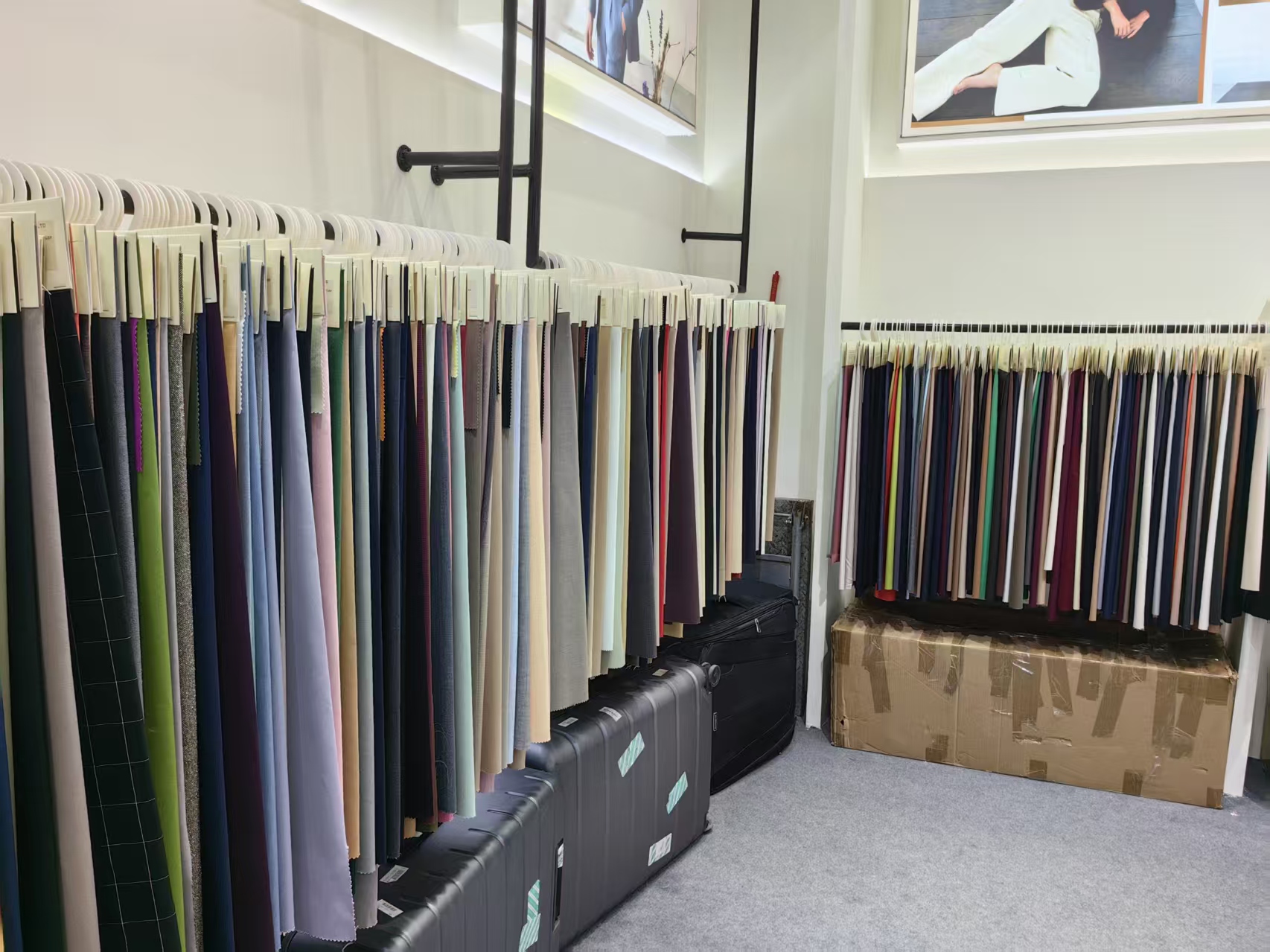 Lookbook wall photos above a fabric rack